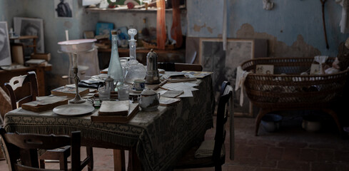 Abandoned Vintage Room with Antique Furniture and Dusty Glassware in Derelict House Interior