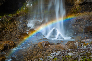 Comet falls rainbow on sunny day at Mount Rainier National Park