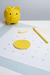 Calendar and yellow piggy bank. Payment of rent housing loans. Financial literacy. Payment time 
