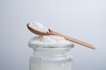 Close-up of magnesium salt flakes. Spa body care and magnesium therapy. White salt, cotton towels, eco-friendly products for home relaxation spa.