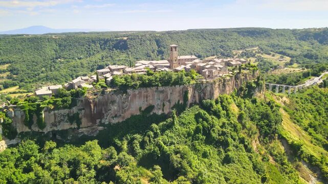 Panoramic aerial view of Civita di Bagnoregio from a flying drone around the medieval city, Italy