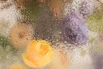Fototapeta premium Smoke selected soft focus flower bouquet through glass with wet water drops. Abstract natural blur background.