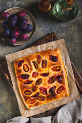 Sweet homemade focaccia with berries on paper on the table top and vertical view