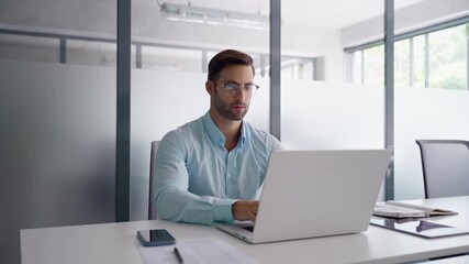 Young professional specialist latin hispanic business man working on laptop pc, doing trade analysing sitting in office. European businessman entrepreneur using computer technology app for work online - Powered by Adobe