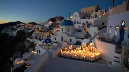 Santorini Greece Good Friday Easter celebration with candle lights glowing on rooftops in Pyrgos village