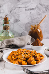 Spicy miso pasta shells on a plate on the table vertical view