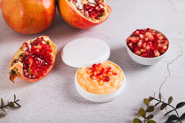 Natural cosmetics with pomegranate for skin care on the table