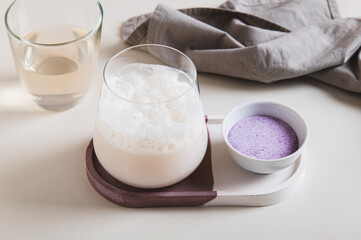 Cloudy pink matcha with taro vegetable in a glass on the table