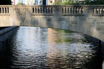 Bridge arch and rippled water surface