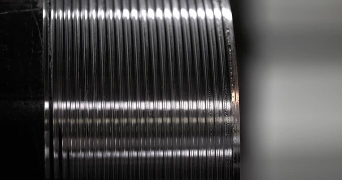 close-up of a metal thread carved on a lathe demonstrates the craftsmanship of the parts as the camera smoothly zooms in on the image to reveal texture and luster