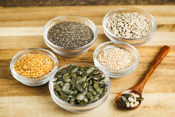 Naklejka premium Assorted Bowls with Mixed Seeds (flaxseed, chia, sesame, pumpkin, and sunflower seeds)