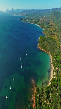 Aerial view of Fort Bregancon sunset aerial view from the mediterranean sea. A yacht is anchored near the fortress