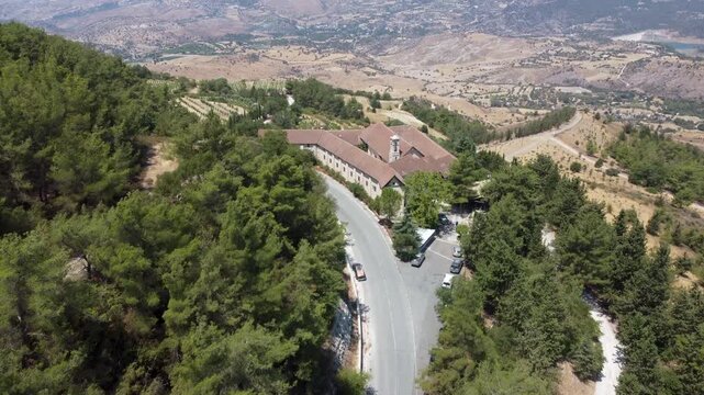 Forward reveal aerial footge of Chrysoroyiatissa Monastery on sunny summer day. Pano Panagia, Cyprus.