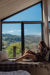 Cozy cabin retreat with mountain views and a woman reading