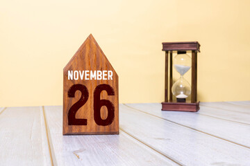 November 26. 26th day of the month, wooden calendar isolated on a white background with shadow