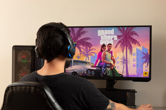A man gamer using gamer earphones playing grand Theft auto 6 video game