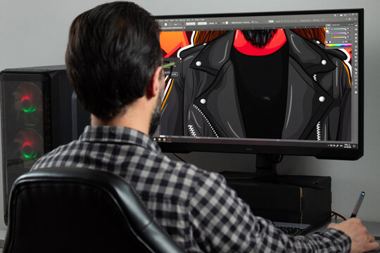a graphic designer man backward drawing a vectorial illustration into adobe illustrator sofware in a gamer computer