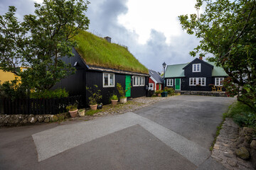 Traditional turf-roofed wooden houses with green doors