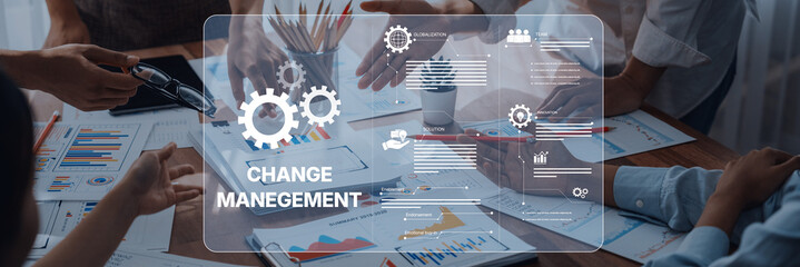 Diverse team engaged in a strategic meeting focused on change management, utilizing visual data analytics to drive organizational success and enhance collaboration. Trope