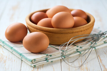 natural organic chicken eggs  on a light kitchen table, selective focus.