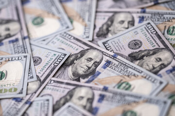 Money background with 100-dollar bills. Texture of US money currency. 100 USD banknotes in focus. American hundred-dollar money. Pattern of US dollars. Money for finance concept.