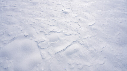 Frosty winter background with snow and ice texture. White snowy field covered with snow. Frozen surface with cold winter pattern. Snow backdrop. Minimal winter background with white snow.