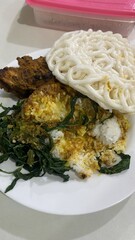 Traditional Asian Fried Rice with Vegetables and Crispy Egg Noodles on White Plate