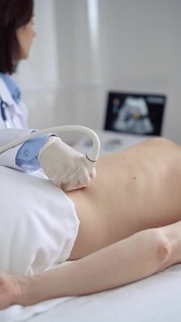 Doctor woman with white medical gloves performing ultrasound examination on patient's back