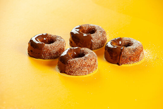 Chocolate sugared with melted icing and filling brioche doughnuts.