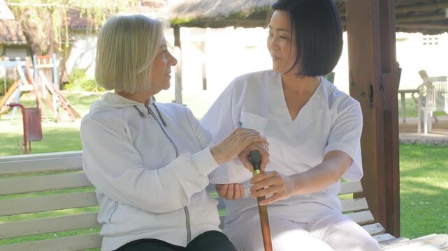 Elderly woman receiving professional help from doctor in rehab clinic for recovery and wellness