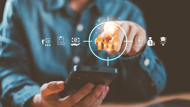 Insurance and family protection concept with digital icons of health, finance, and education, showing hand pointing to family target symbol on smartphone for policy, security, and planning themes. - Powered by Adobe