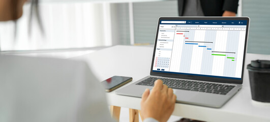 Project planning software for modish business project management on the computer screen showing...