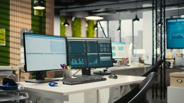 Empty corporate office features high tech technology and dual monitors, analytics tools ready for business strategy and report writing. Professional growth and organizational success.