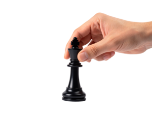 Close-up of a hand using a precision grip to lift or place a black chess King piece by its cross top, showing a strategic move, isolated against a light gray background.