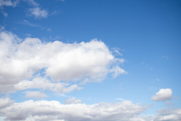 Fototapeta premium Blue sky with white fluffy clouds background