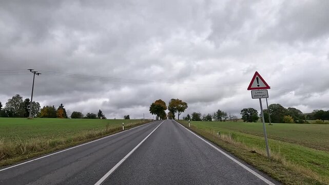 Dresden Germany rural village buildings road 2. Driving point of view. Industrial center of East Germany, now unified German, European Union (EU) and NATO. Total destruction in WW II and now rebuilt.