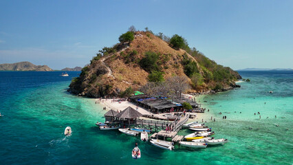 Drone view of Pulau Kelor surrounded by crystal clear waters in Komodo archipelago, Indonesia