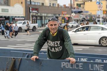 Smiling tourist enjoying the vibrant atmosphere and colorful urban scenery of Coney Island