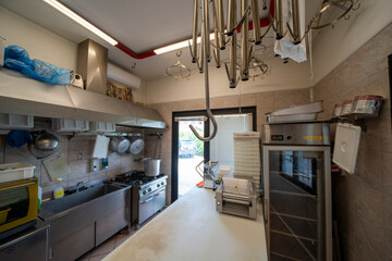 Interior view of a traditional butcher shop where fresh meat is being expertly cut