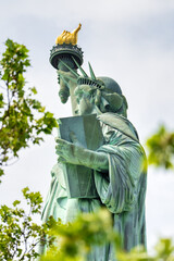 Profile view of the iconic Statue of Liberty showing torch and crown from the side © jovannig