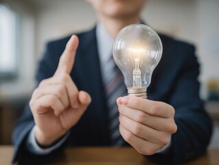 Japanese businessman holding lightbulb idea innovation solution creative thinking concept