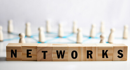 Networks spelled on blocks with connected figures and linking lines illustrating collaboration flows and information exchange across a distributed system, representing social graphs 