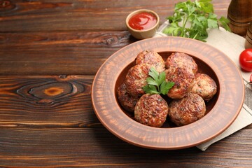 Roasted meat patties served on wooden table. Space for text