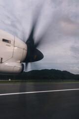 Airplane propeller spinning on the wing, preparing for takeoff or landing at an airport runway © Felix Morion