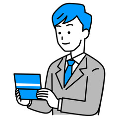 預金通帳を見るスーツの男性