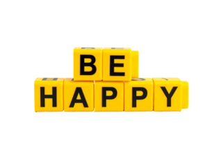 Be Happy" spelled with yellow toy blocks on black