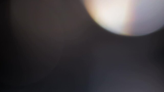 Multicolored light leaks 4k footage on black background. Lens studio flare leak burst overlays. Natural lighting lamp rays bokeh effect. For compositing over your footage, stylizing transitions