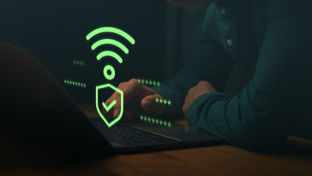 Man using a laptop computer with Wi-Fi security icon and checkmark, symbolizing safe internet connection, encrypted access, cybersecurity, and password protection for online data.