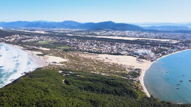 Panoramic aerial view of Santinho Beach and Ingleses Beach in Florian&oacute;polis, Santa Catarina, restinga area and dunes seen from the top of Ingleses Hill on a beautiful sunny day.