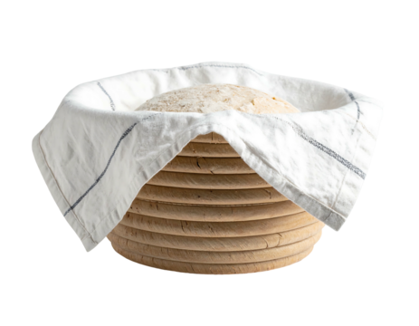 Dough resting in lined brotform Unbaked bread, dusted with flour, rests inside a banneton, covered by striped cloth